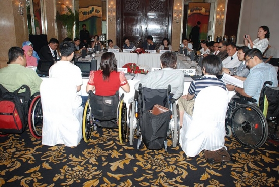 <p>
	The regional council members are seated around a large rectangular table.</p>
