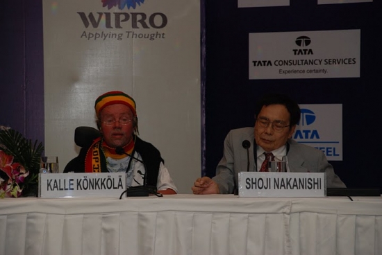 Mr. Kalle Konkkola of ABILIS Foundation in Finland (left) and DPI Asia Pacific Chairperson Mr. Shoji Nakanishi of Japan (right) seated at the presenter's table. 