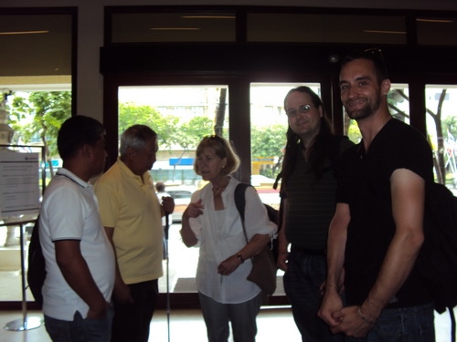 Five people are in this photo, three are facing the camera and two are looking at the others in the photo. They might have been having a conversation when the photographer took the photo. The people are: Christopher Lytle (right), Nathan Bond 
(2nd from right),Marcia Rioux (centre), Lauro Purcil (2nd from left) & Ranil Sorongon (left). 