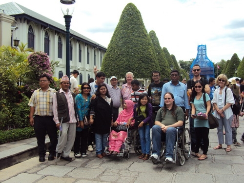 Participants and facilitators pose near the Grand Palace for a group photo. 