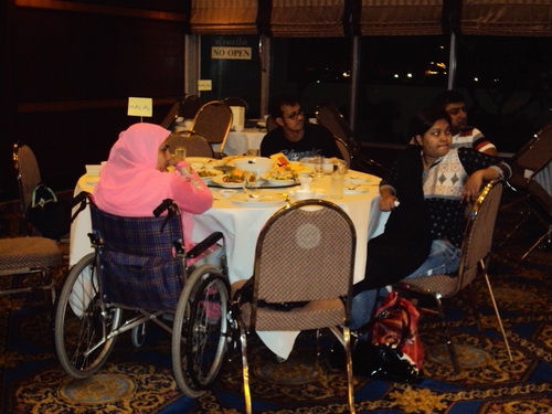 Participants sit around a table with food: Ashrafun Nahar (left), Roosevelt D'Rozario (2nd from left), Farhana Mustary (right) and MD Rasel (behind Farhana). 