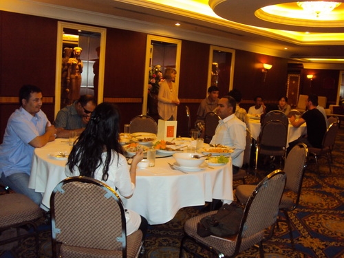 Marcia Rioux stands and welcomes the seated participants. 