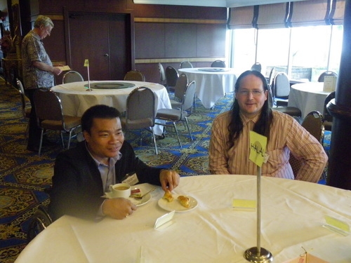 Nathan Bond and Chaiya Munsan sit at a table. 