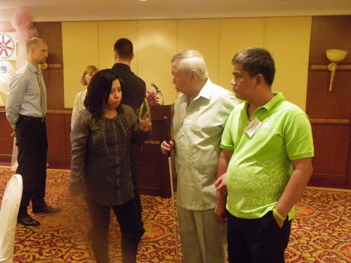 Marie Ann Fernadez talks to Lauro Purcil and Rannil Sorongon in the training room. 