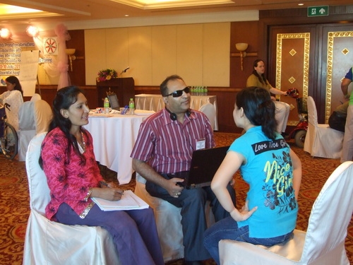 Mr. Birendra, Ms. Ram and Chona Sabo sit closely together and practice interviewing skills. 