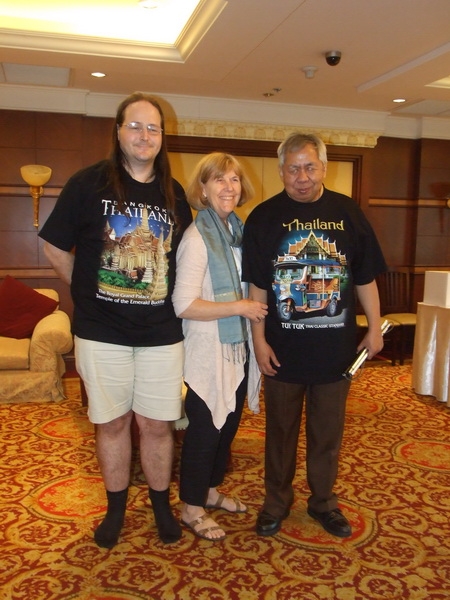 Nathan Bond, Marcia Rioux and Lauro Purcil stand together and smile for a picture inside the hotel. 