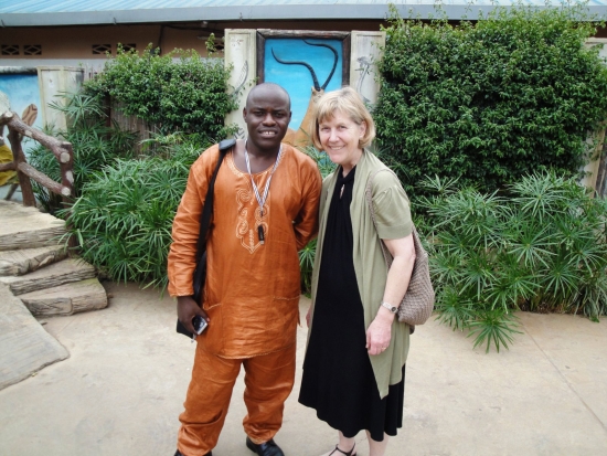 <p>
	Professor Marcia Rioux and Oswald Tuyizere taking a photo on the wall of the hotel hosted the meeting.</p>
