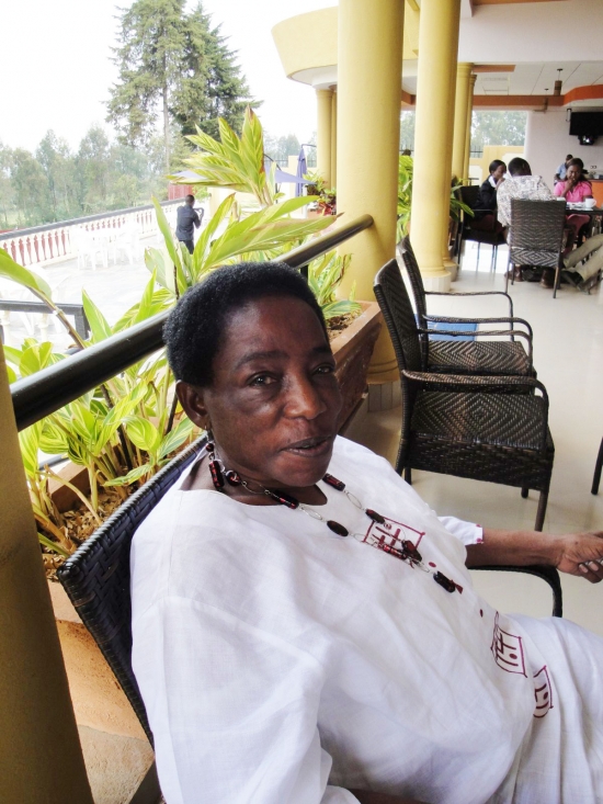 A woman reclines in a chair on a veranda.