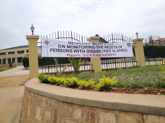 <p>
	A banner announcing the regional training hangs in front of a large yellow-coloured hotel.</p>
