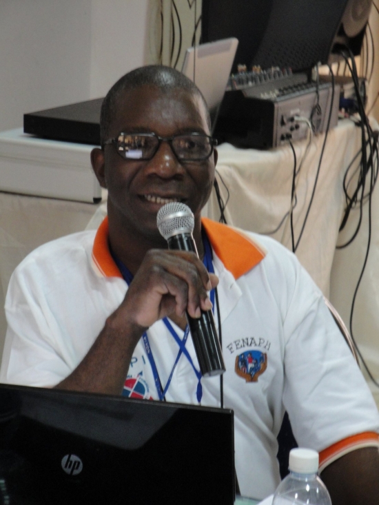 Robert Mkozho speaks into a microphone.