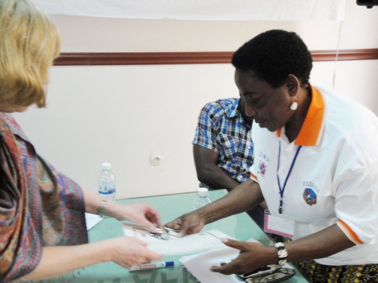 Magdalena Tiba Kaihuzi is handed a certificate by Marcia Rioux
