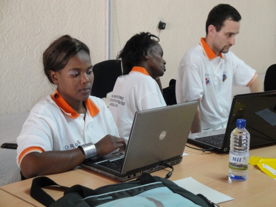 Bongi Malope, Mercy Murgure and Chris Lytle work on laptops.