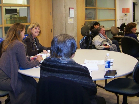 Sandra Carpenter, Dr. Marcia Rioux and Dr. Roxanne Mykitiuk are sitting at a tab