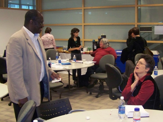 Numerous participants are conversing in small groups throughout the room.