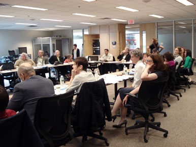 <p>
	Delegates sitting around a conference table, the delegates face each other and listen to a presenter who is outside the frame.</p>
