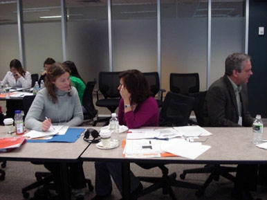 <p>
	Two delegates sit side by side at the meeting table, as they discuss monitoring.</p>
