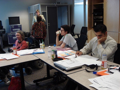 <p>
	Sandra Carpenter is to the left of the frame as she glances towards the camera. Other people in the frame are taking a sip of coffee, studying or having discussions.</p>
