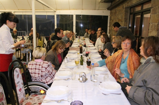 <p>
	Participants sit at a long table set for a meal in the restaurant in Novi Kneževac.</p>
