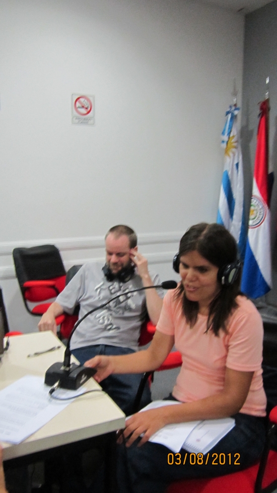 <p>
	Marcela Omedo at a table, speaking to the larger group during the training; German Sciurano is on her left.</p>
