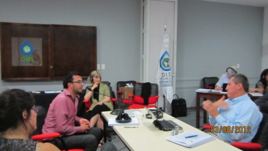 Jose Leal signing during the training; the sign language interpreter is interpreting; Marcia Rioux is at the back listening.