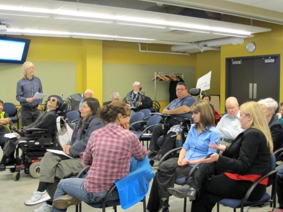 <p>
	Participants sit in the foreground while a man (Robin Loxton) stands to the side and presents.</p>
