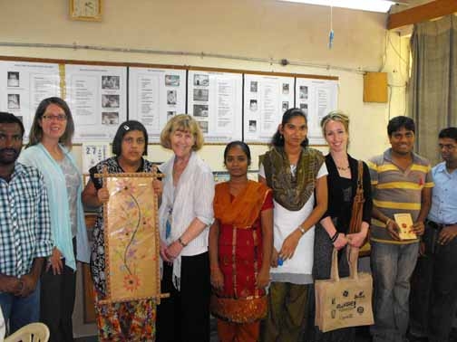 <p>Paula Hearn, &nbsp;Marcia Rioux and Alexis Buettgen pose indoors with students in training at the National Institute for the Mentally Handicapped.</p>
