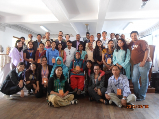 <p>
	Participants gather for a group photo, some are standing and some are seated on the floor.</p>
