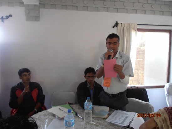 Yuba stands to read from an assignment that his group completed. 