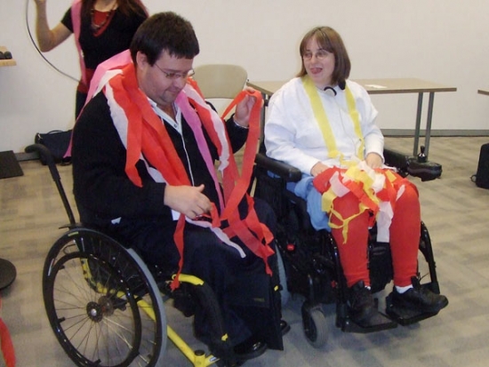 Two participants covered in streamers at the end of the training, both are smiling. 