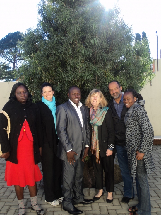 Roseweter Mudarikwa, Rita Samson, Oswald Tuyizere, Marcia Rioux, Moosa Salie and Mercy Gichunge are posing a group photo behing the training venue.