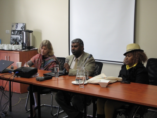 From left to right: Prof. Marcia Rioux, Jair Nair and Bongiwe Malope are sitting at a table in front of a white screen. 