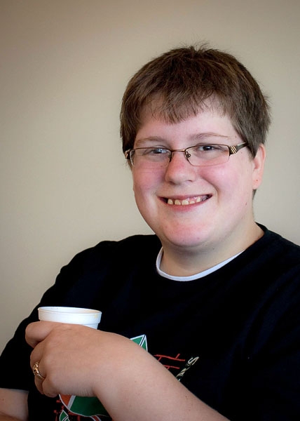 Deborah Gilbert smiling while holding a styrofoam cup.