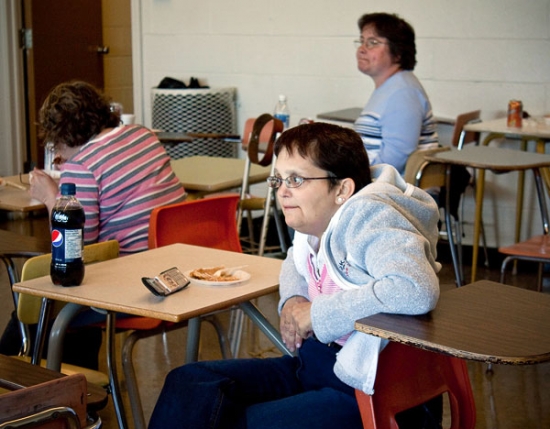 Lynn Seaward is sitting at a desk.