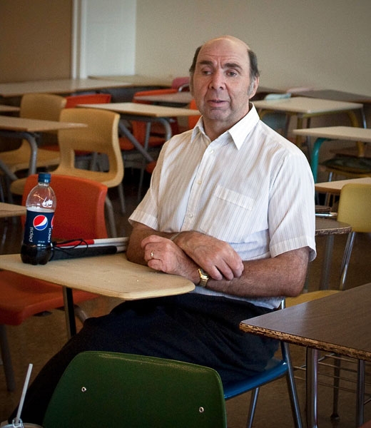 Paul Morgan sitting at a small desk.