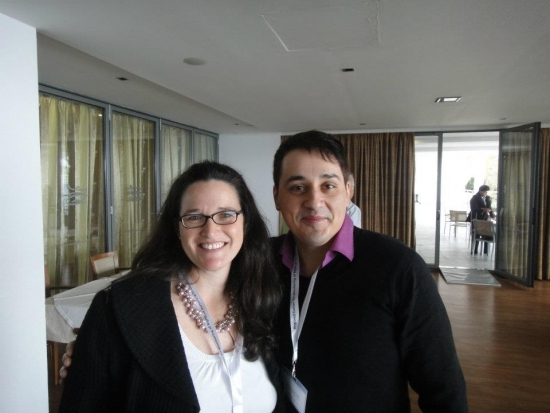 Rita Samson and Goran Loncar stand side by side to have their picture taken, both are smiling. 