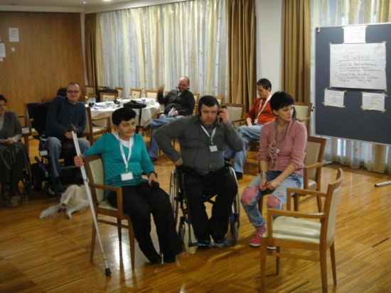 Desa Peruničić, Mersad Muric and Sonja Smajic all listen to translation after an evening activity. 