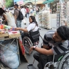 The participants shop in the market (sitting in the wheelchair)