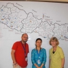 <p>Marcia Rioux poses with two staff persons from Handicap International, Nepal in front of a white board with a map.</p>
