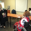 <p>
	Prof. Marcia Rioux is showing a T-shirt to Bongiwe Malope as a sign of her gratitude for organizing the workshop successfully. They are in front of a table and there is a white screen on the wall in the background.</p>
