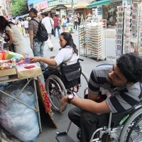 The participants shop in the market (sitting in the wheelchair)