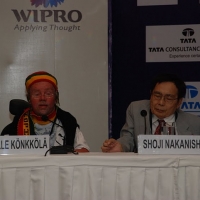 Mr. Kalle Konkkola of ABILIS Foundation in Finland (left) and DPI Asia Pacific Chairperson Mr. Shoji Nakanishi of Japan (right) seated at the presenter's table. 