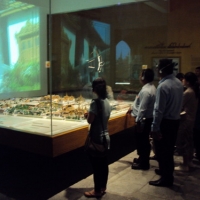 Chona Sabo, Regional Officer of DRPI-AP (left) with the group of participants (right) view a miniature model of Bangkok while listening to its breathtaking history. 