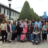 Participants and facilitators pose near the Grand Palace for a group photo. 