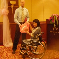 Mr. Patrik Andersson smiles while being handed a token of gratitude by Ms. Saowalak Thongkuay.