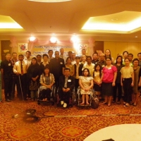 Participants and facilitators pose for a group photo inside the training room. 