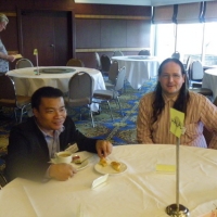 Nathan Bond and Chaiya Munsan sit at a table. 