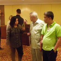 Marie Ann Fernadez talks to Lauro Purcil and Rannil Sorongon in the training room. 