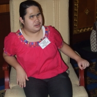 Krongkaew Jindapong sits in a chair. 