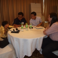 People sitting at a round table talking. 