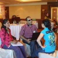 Mr. Birendra, Ms. Ram and Chona Sabo sit closely together and practice interviewing skills. 